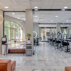 Spacious and modern beauty salon interior with stylish decor and lighting.